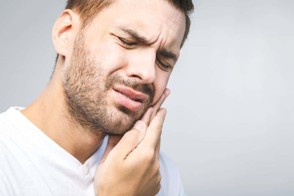 Long-Beach-dental-patient-experiencing-jaw-pain-tmd-Treatment